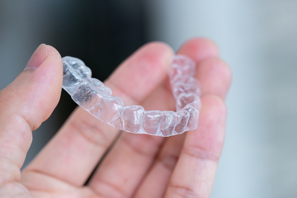 Clear,Aligners,Device,In,The,Mouth,On,A,White,Background.